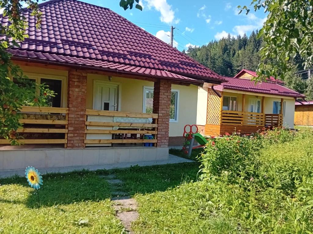 a small house with a red roof at Cabanute pitoresti Poiana Largului in Poiana Teiului