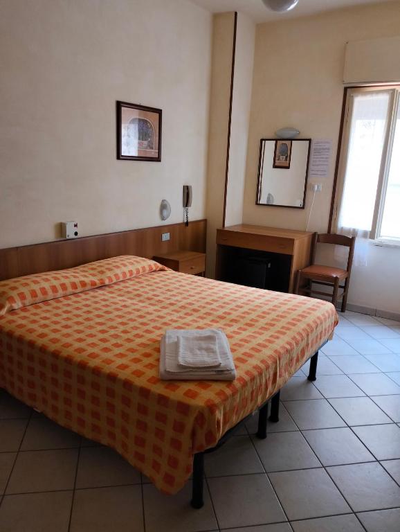 Postel nebo postele na pokoji v ubytování Albergo Rosa & Cosetta