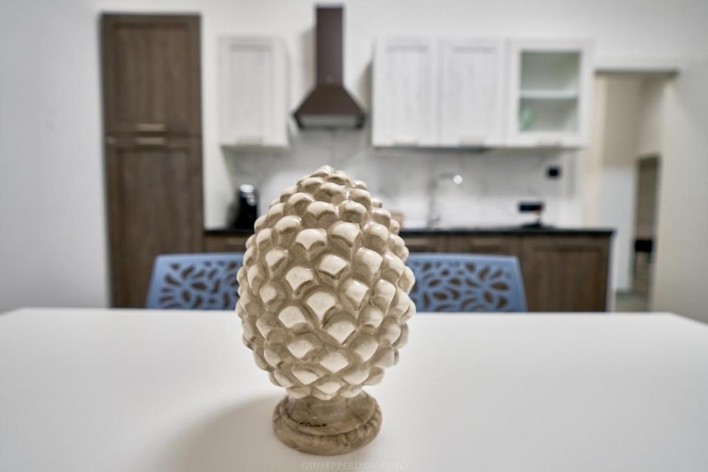 a pineapple sitting on top of a table in a kitchen at La Maison Apparthotel in Praia a Mare