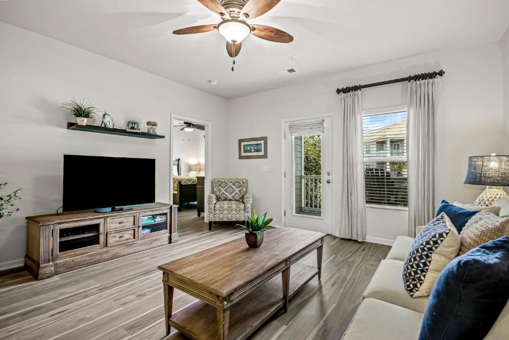 a living room with a tv and a couch at Yellow Daisy & Beach Escape in North Myrtle Beach