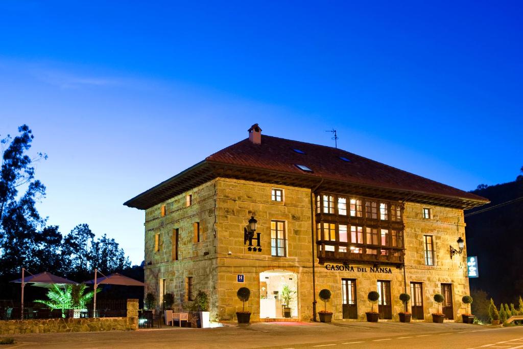 a large brick building with a large window at Casona del Nansa in Herrerias