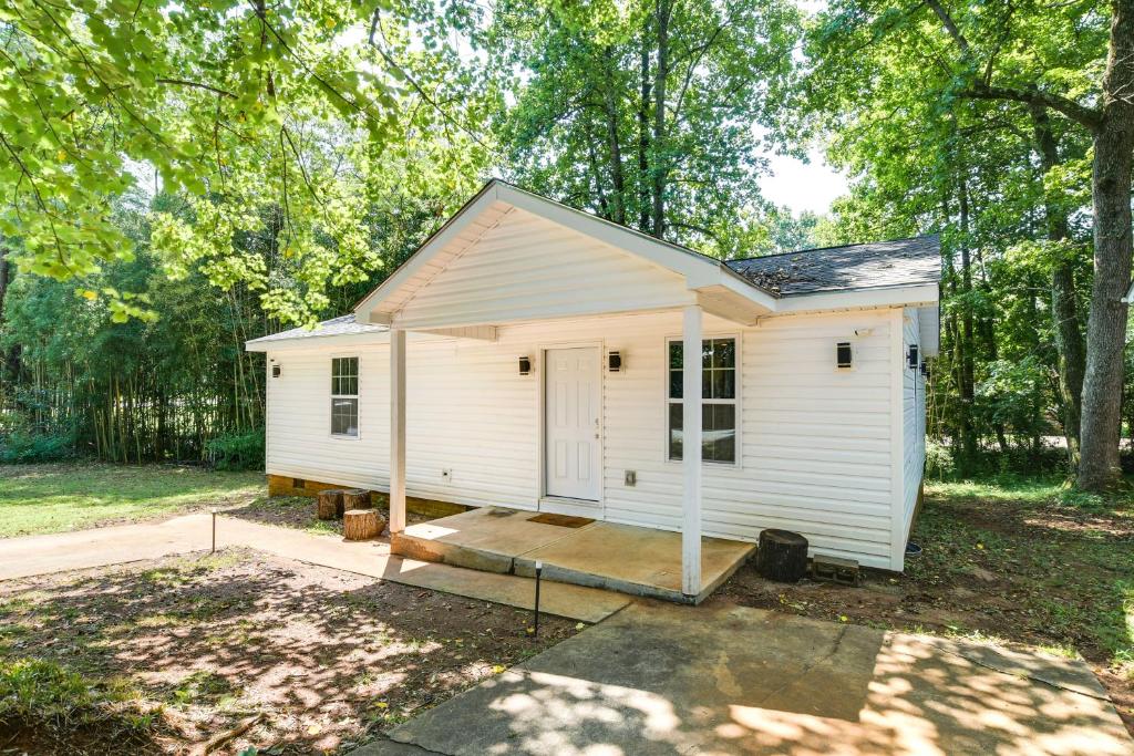 a white tiny house in the middle of a yard at Greer Vacation Rental about 11 Mi to Greenville! in Greer