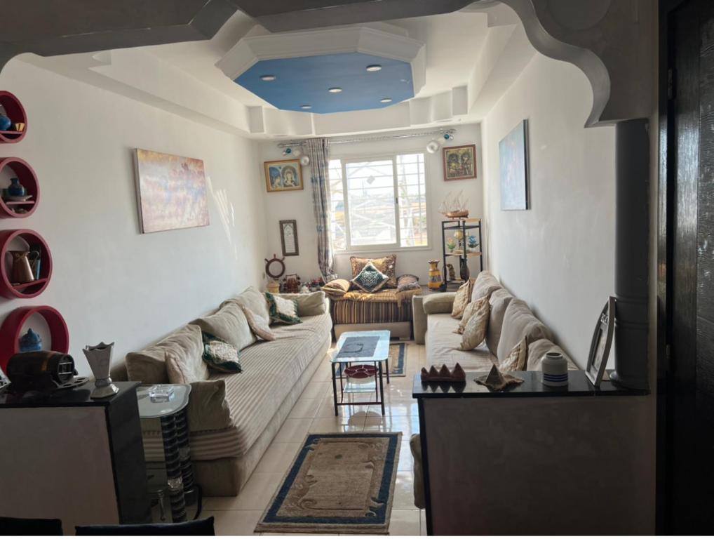a living room with a couch and a table at Skhirat Résidence Nour 1 Im C N5 in Skhirat