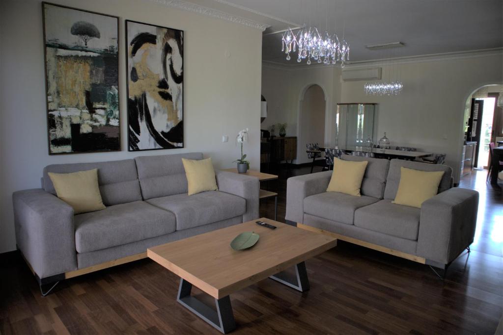 a living room with two couches and a coffee table at Kouros At The Park in Alexandroupoli