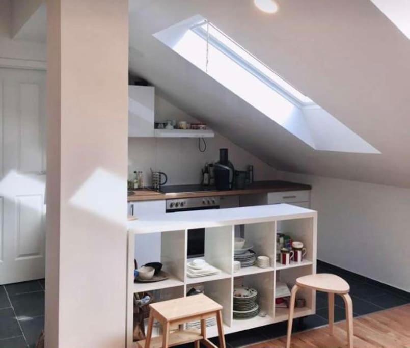 a kitchen with a white cabinet and two stools at Sonnige und ruhige Wohnung für entspanntes Reisen in Vienna