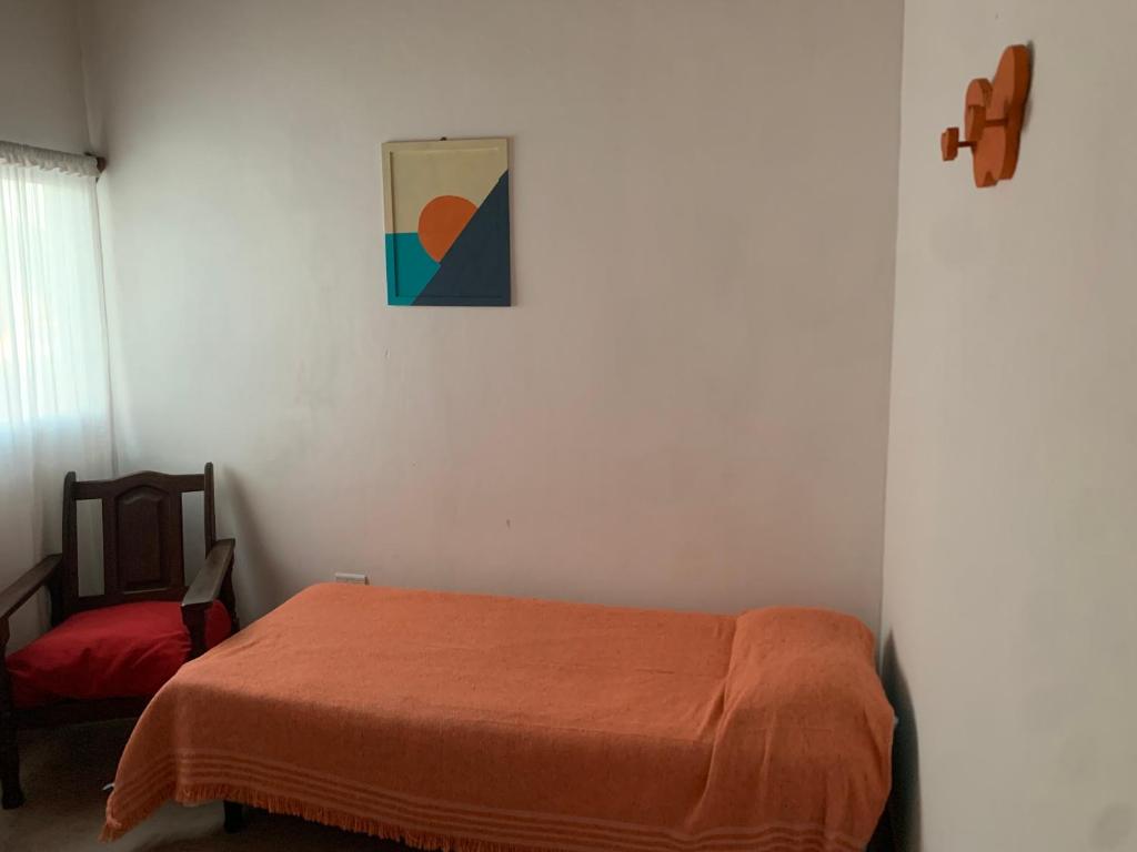 a bedroom with a bed and a picture on the wall at Departamento MPM 2 in Mercedes