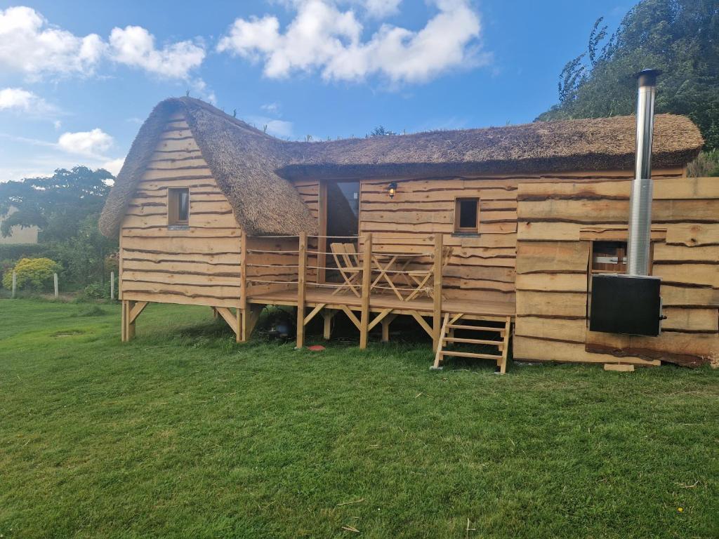 a large wooden house with a large deck at Chalet du bonheur de campagne 