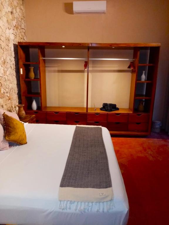 a bedroom with a bed and a dresser with a mirror at Hotel Boutique Refugio 41 in Valladolid