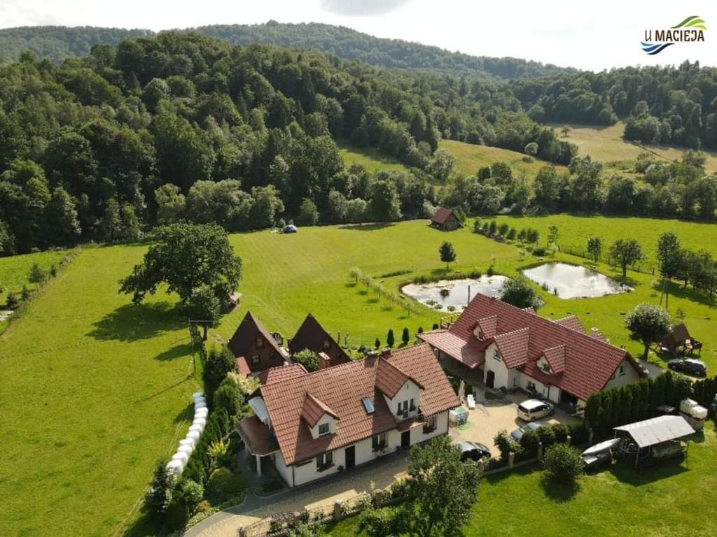 an aerial view of a large house in a field at Agroturystyka "U Macieja" in Teleśnica Oszwarowa