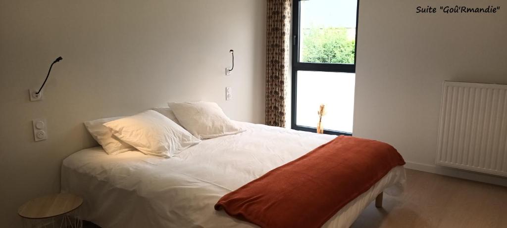 A la Lueur des Prés : سرير أبيض في غرفة بها نافذة