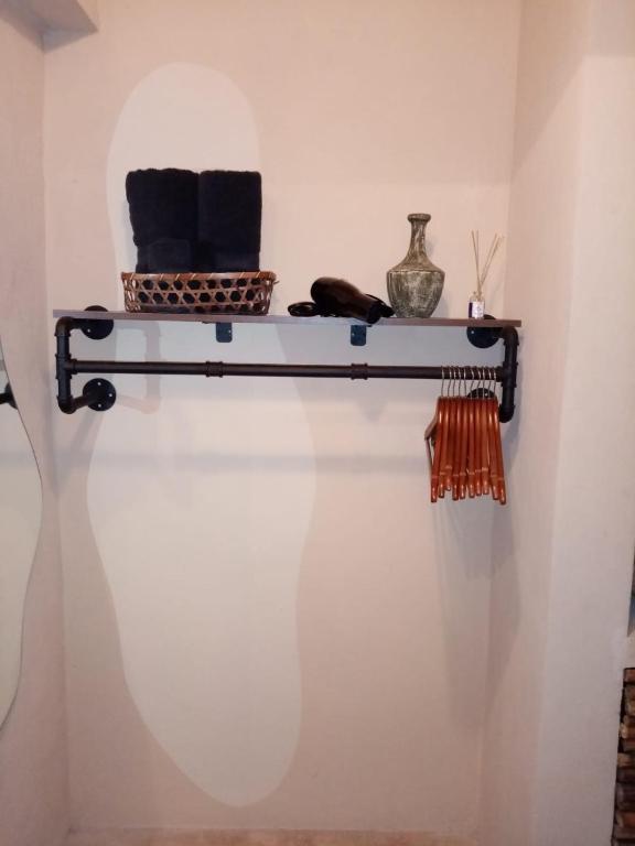 a shelf on a wall with towels on it at Hotel Boutique Refugio 41 in Valladolid