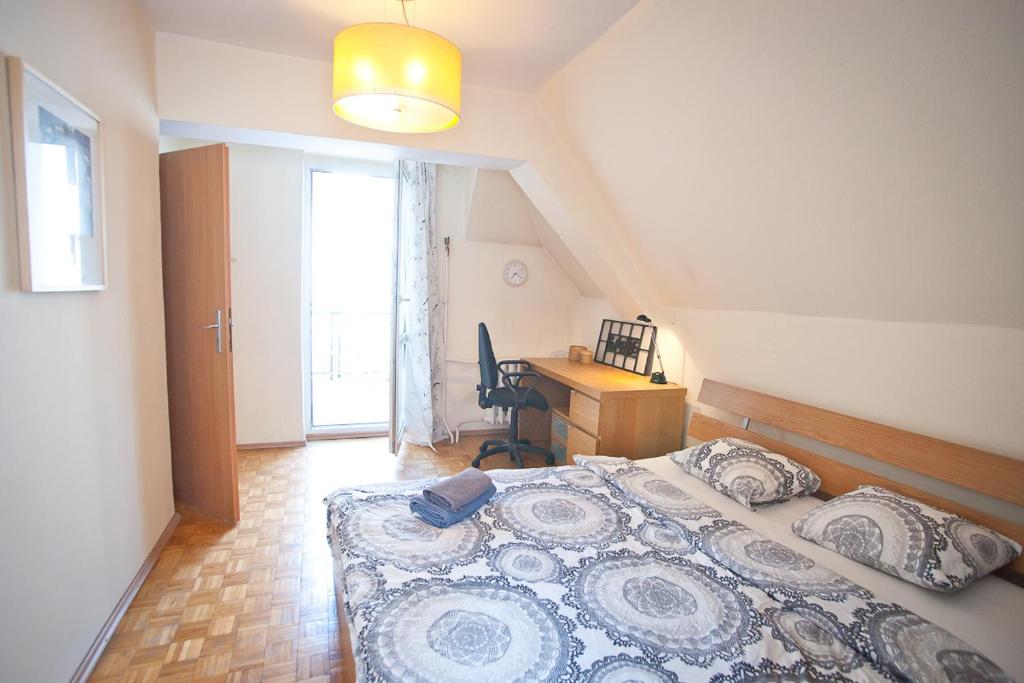 a bedroom with a bed and a desk in it at Center Rynek in Wrocław