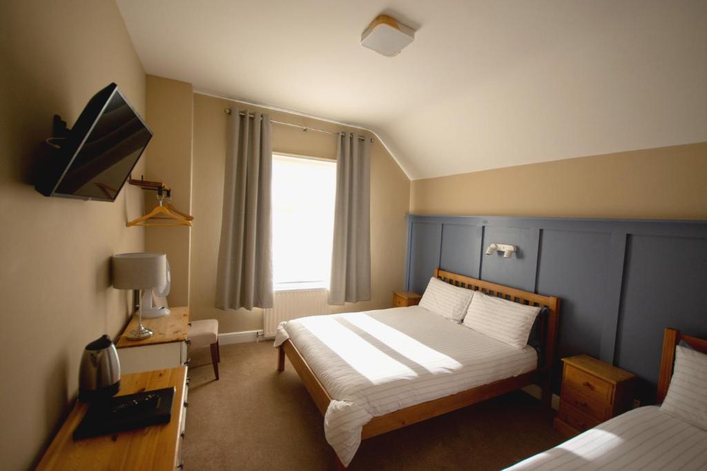 Ένα ή περισσότερα κρεβάτια σε δωμάτιο στο Salamander Guest House