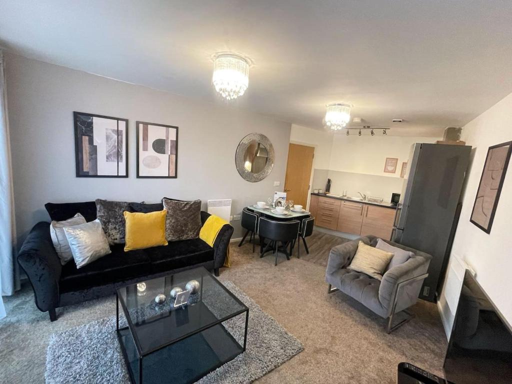 a living room with a couch and a table at Cityfront Cosy Apt Near City Centre & Etihad Stadium, Free Parking in Manchester