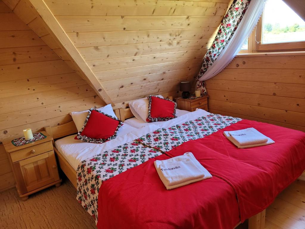 Domki Tatry في شافلاري: غرفة نوم بسريرين في كابينة خشب