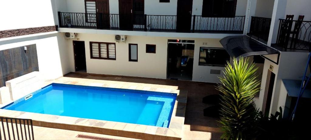 a large swimming pool in front of a house at Hotel Las Pascuas in Tarija