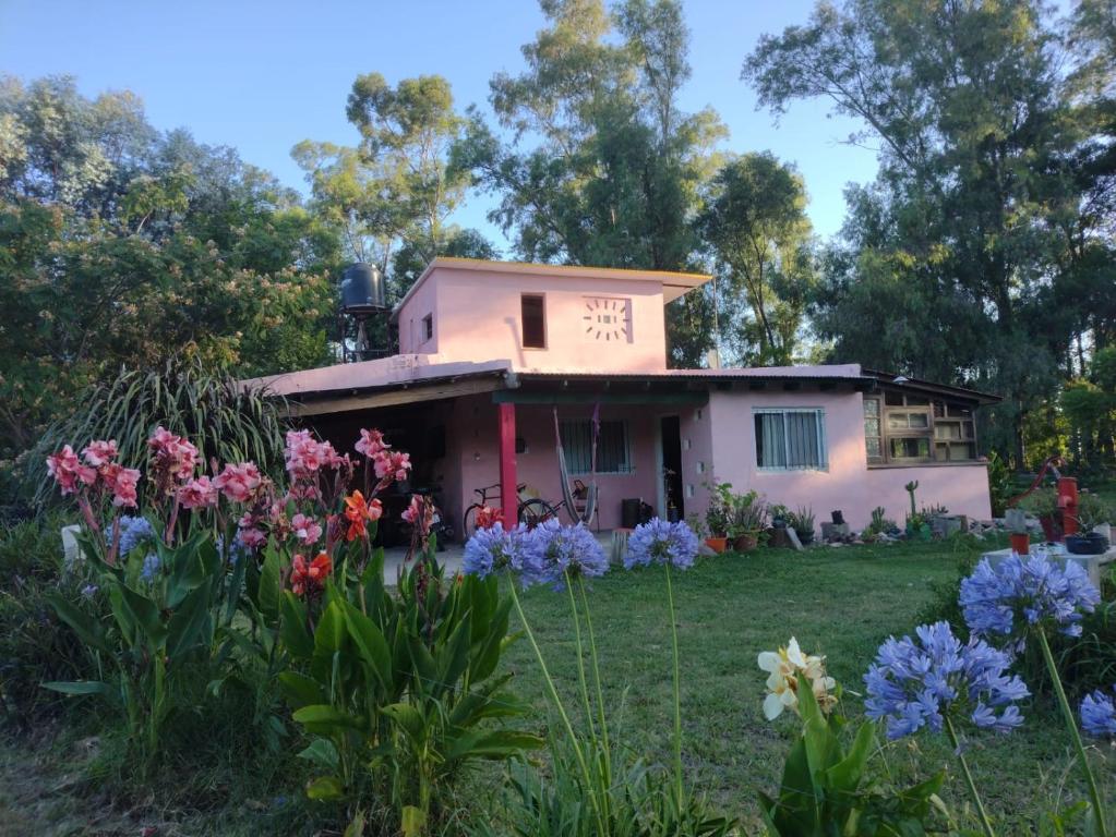 a house with flowers in front of it at La casa de Sibila in Bragado