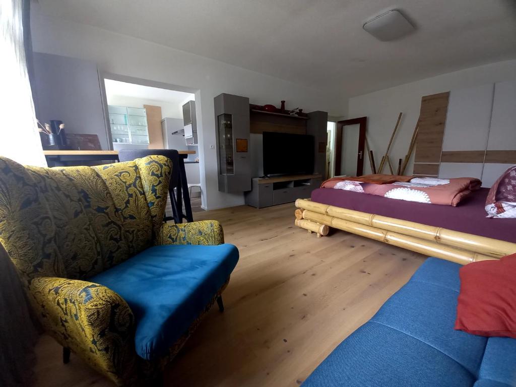 a living room with a couch and a bed at Riccis 47m2 bamboo flat in Grosspertholz