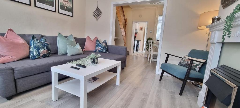 Hotel Toffees Townhouse a 2 Bed House in Liverpool 1 Mins walk to Goodison Park, a living room with a couch and a table at Toffees Townhouse a 2 Bed House in Liverpool 1 Mins walk to Goodison Park in Liverpool