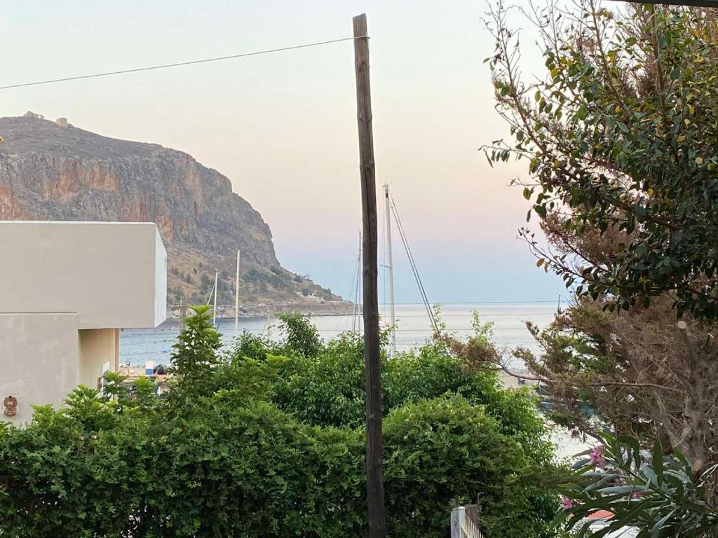 a view of a beach with a mountain and the ocean at Maria’s Apartment in Monemvasia