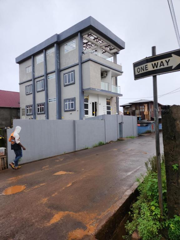 a person riding a skateboard in front of a building at Rooftop Villa in Freetown