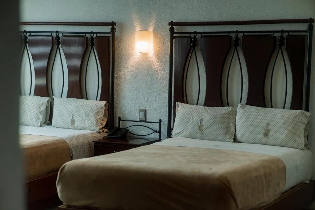 Postel nebo postele na pokoji v ubytování Hotel Alcazar - Guadalajara Centro Historico