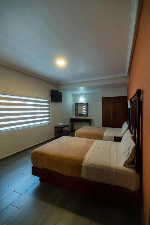 Postel nebo postele na pokoji v ubytování Hotel Alcazar - Guadalajara Centro Historico