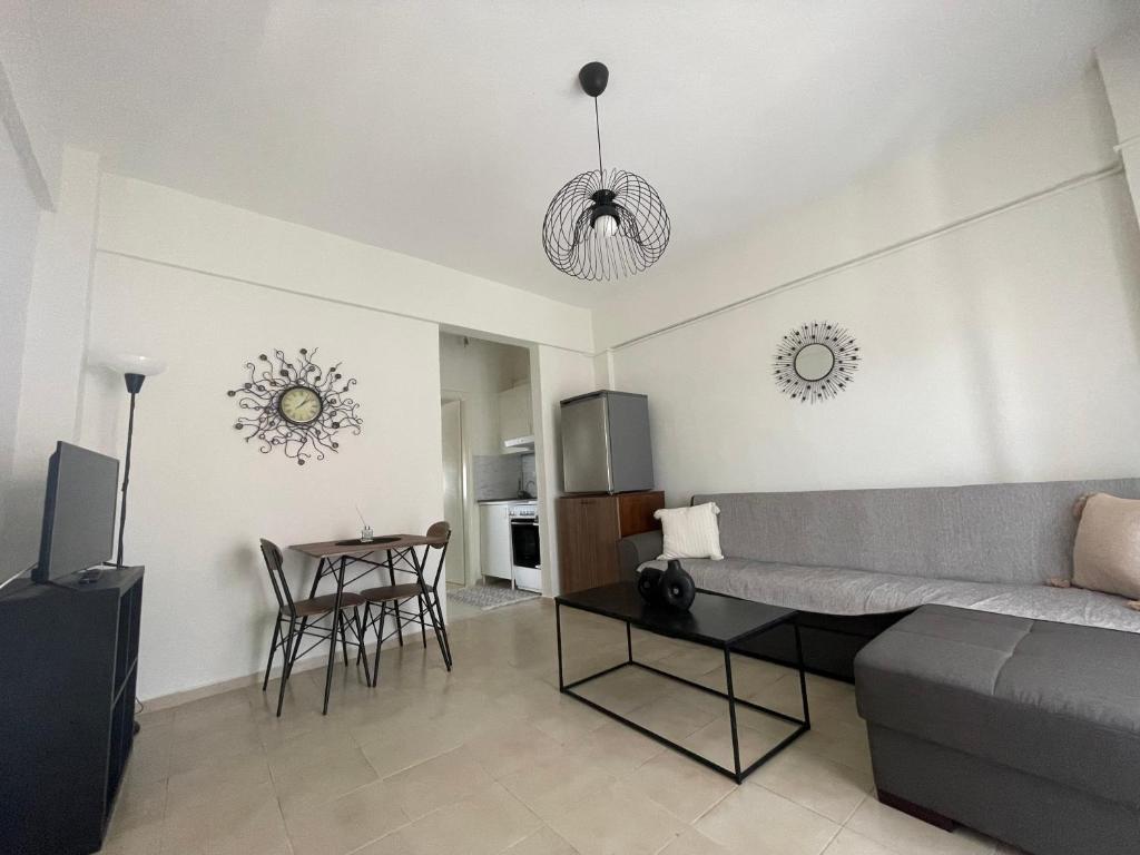 a living room with a couch and a table at Evi's apartment Pefkochori in Pefkochori