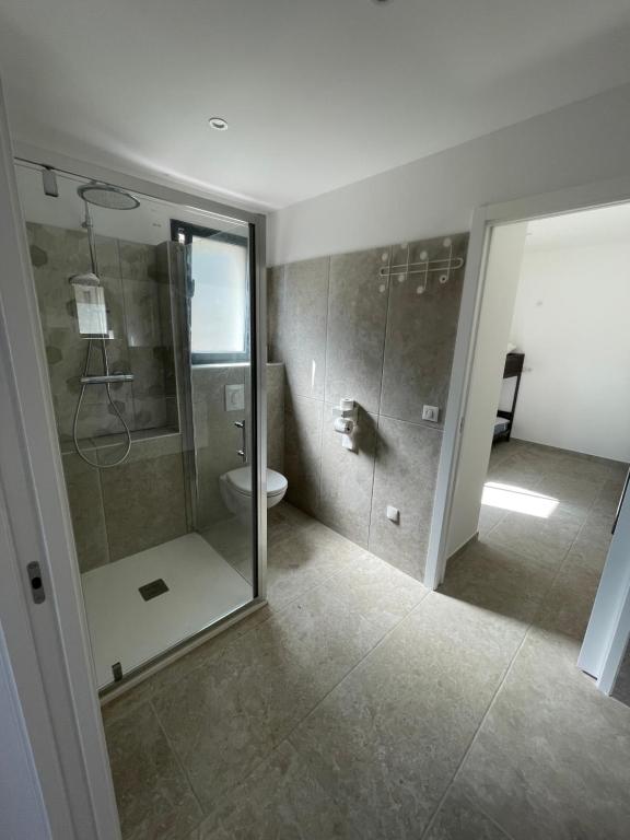a bathroom with a shower and a toilet at Villa de standing in Calvi