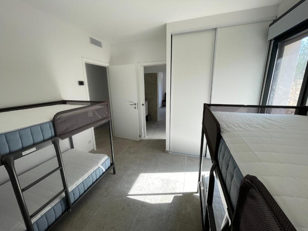 a bedroom with two bunk beds and a window at Villa de standing in Calvi