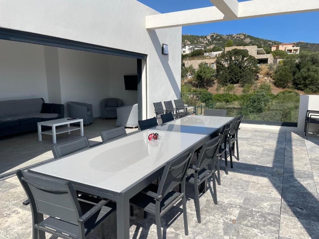 a large white table and chairs on a patio at Villa de standing in Calvi