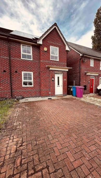 a brick driveway in front of a brick house at 5 STAR LUXURY BIG HOUSE, JACUZZI SPA HOT TUB, PARKING, LIVERPOOL CITY CENTRE, SLEEPS 10, EASY LOCK BoX ENTRY! NO PARTIES! in Liverpool