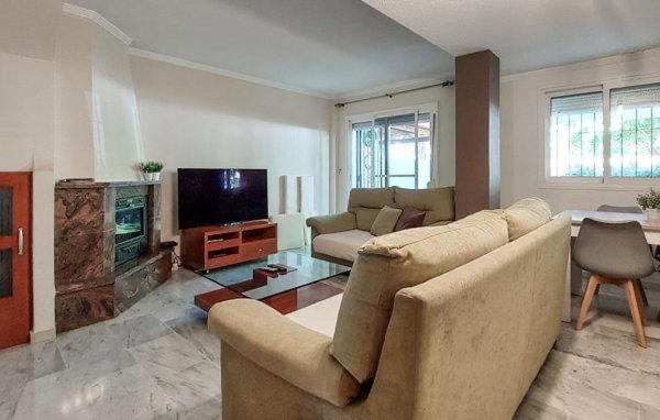 a living room with a couch and a television at Casa Sol & Mar, Rincon de la Victoria, Malaga in Rincón de la Victoria
