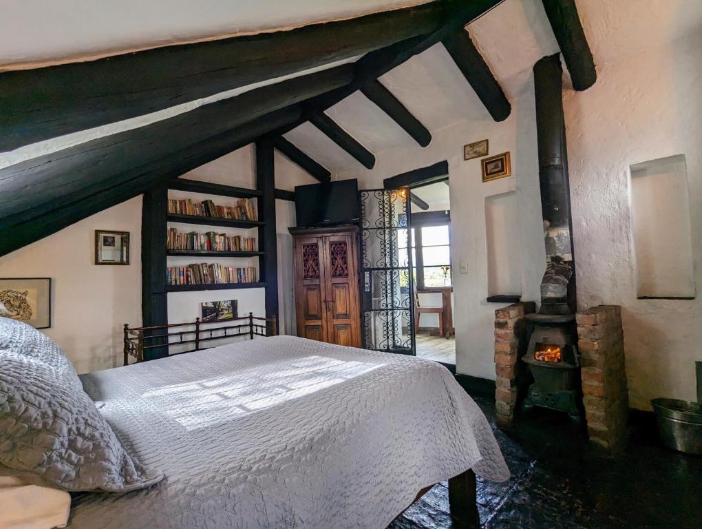 a bedroom with a large bed in a building at Posada Cafe La Huerta in Guasca