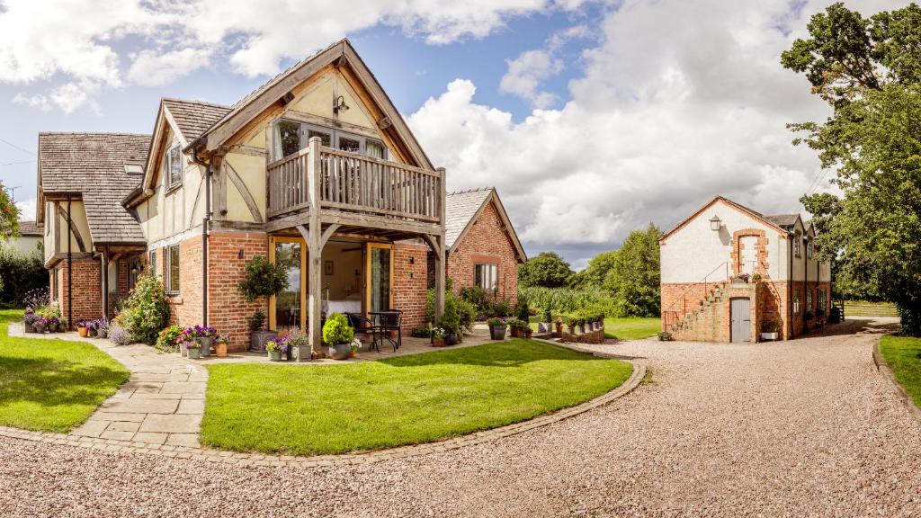 a house with a balcony on a driveway at Oak Mead in Wrexham