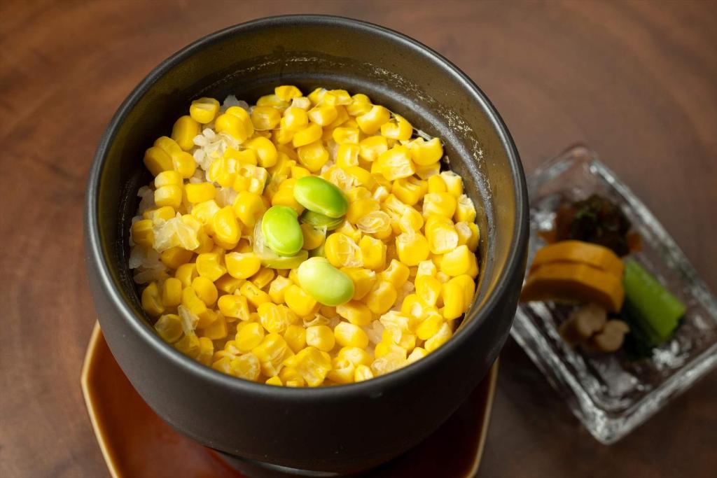 a black pot filled with corn and green onions at Bessho Onsen Midoriya in Ueda