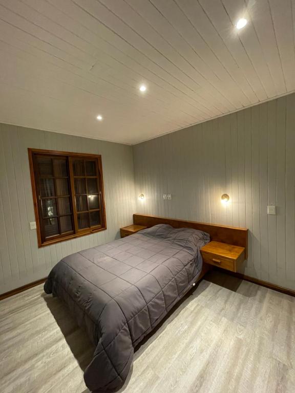 a bedroom with a large bed and a window at Lomas del Paraná in Eldorado