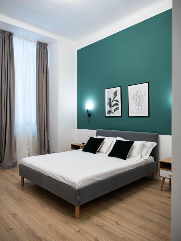 Postel nebo postele na pokoji v ubytování Moor Assarotti Suites - Genova City Center