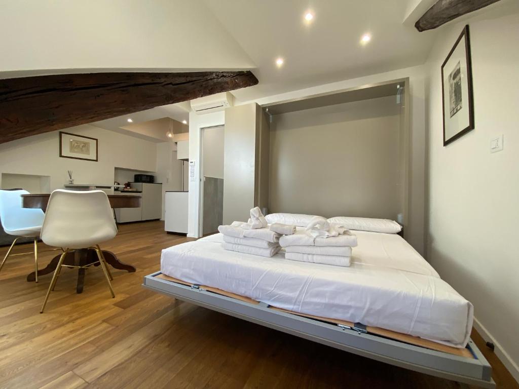 a bedroom with a large bed with towels on it at Hostdomus - G10 Suite in Turin