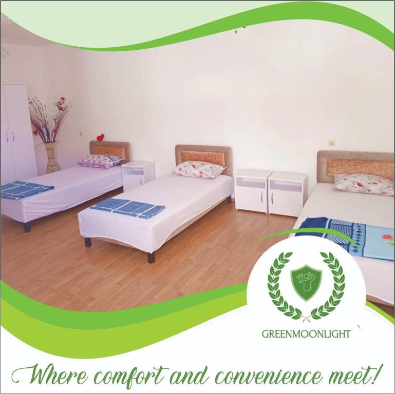 two beds in a room with a greenorgetown logo at Green Moonlight in Ulcinj