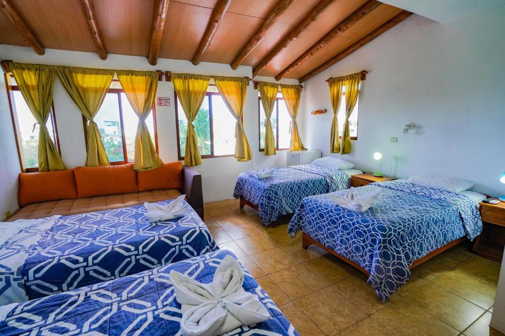 Postel nebo postele na pokoji v ubytování Galapagos Verde Azul