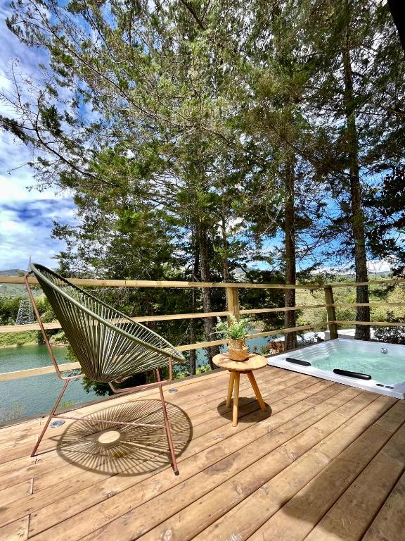 a hammock sitting on a deck next to a pool at Soy Local Guatape in Guatapé
