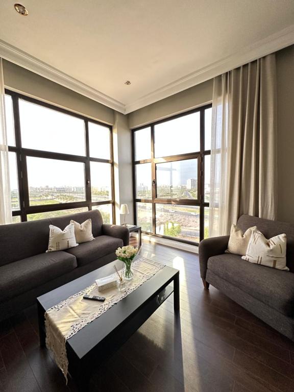 a living room with two couches and a coffee table at Apartment Fourty One in Al Khobar