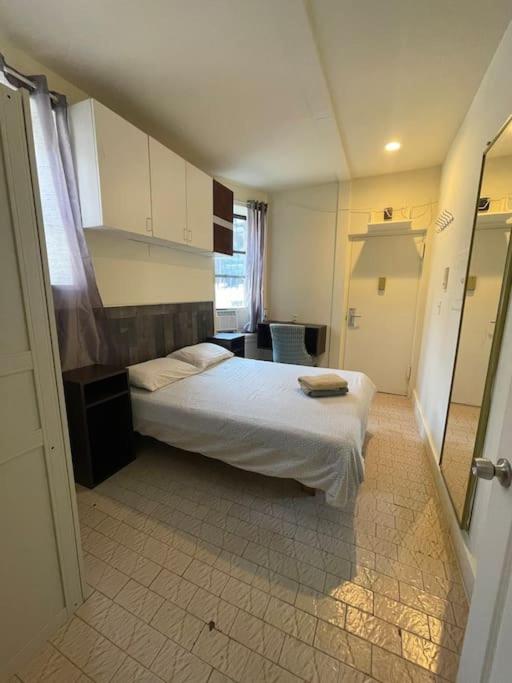 a small bedroom with a bed and a bathroom at 2B CLOSe in New York