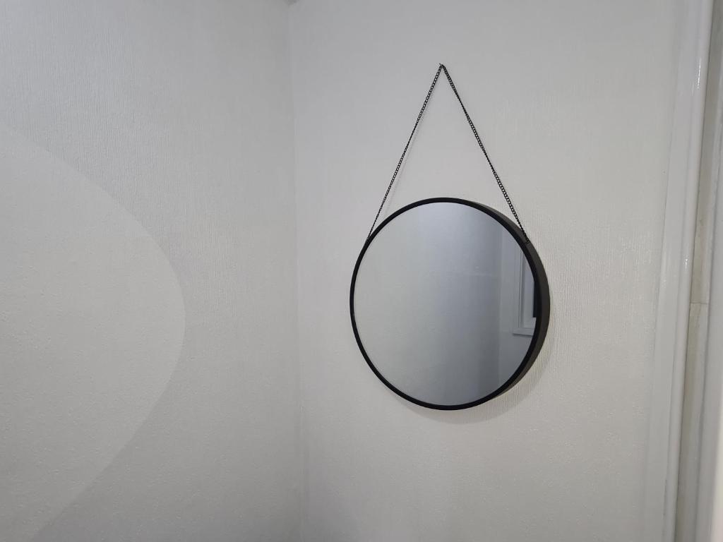 a mirror hanging on a wall in a room at Freshen-Up Stays in Oakengates