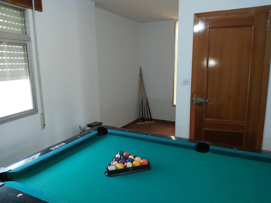 a pool table with a tray of balls on it at Casa Ricardo (16km de Coruña) 