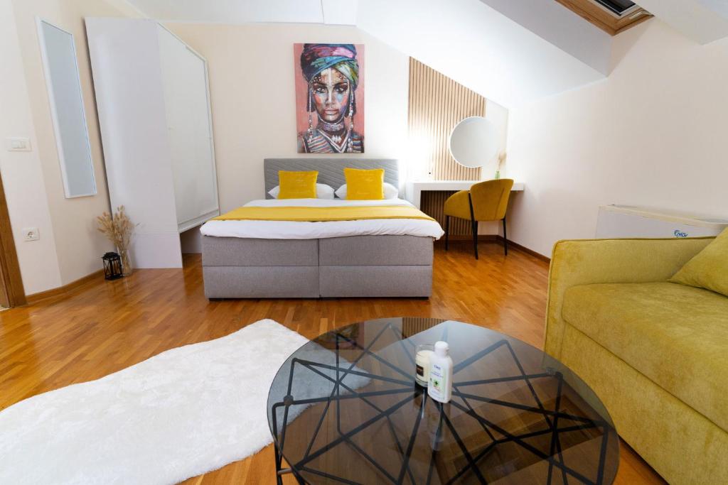 a living room with a bed and a coffee table at Mini Hotel RiverLux Apartments in Bačka Palanka