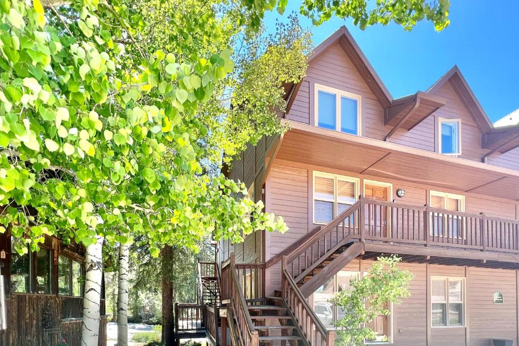 a house with a staircase in front of it at On the Rapids - A Unit in Grand Lake