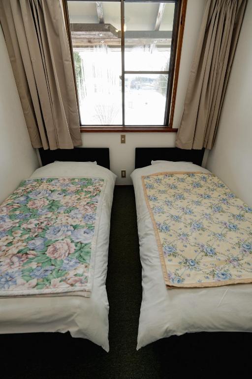 Postel nebo postele na pokoji v ubytování ペンションminiモンゴル