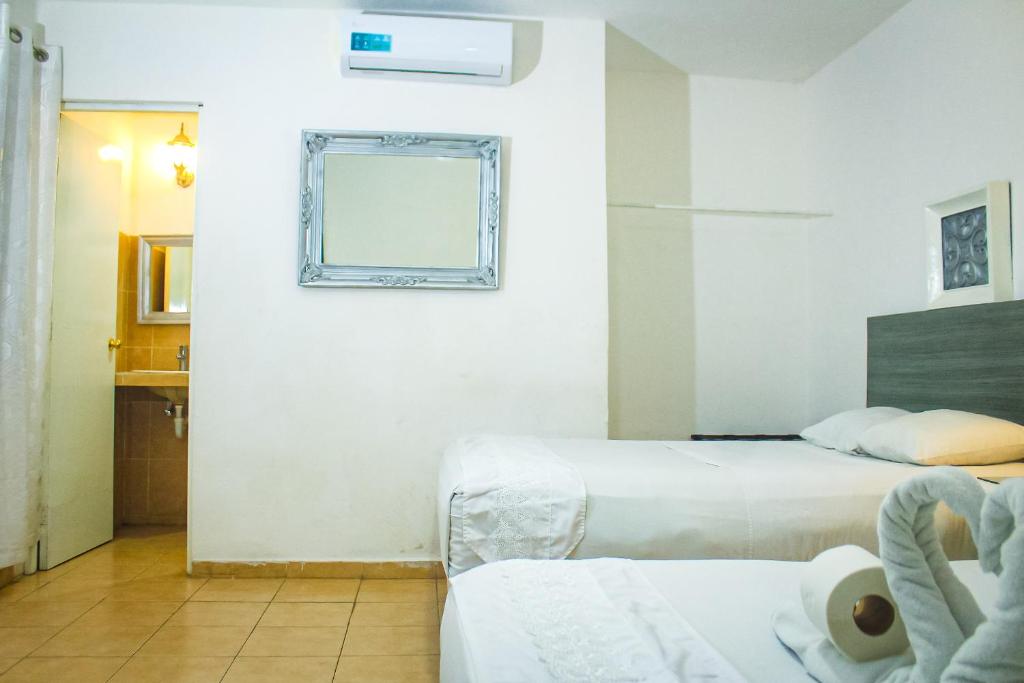 Postel nebo postele na pokoji v ubytování Palacio Canton Hotel - Valladolid